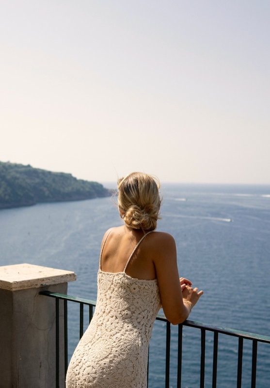 Isabelle on a terrace looking out over the water
