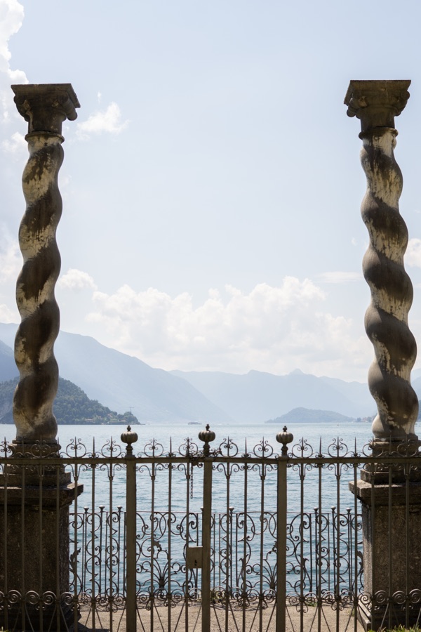 View through twisted stone columns onto the lake and the mountains